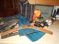 Overview of the outdoor fun lot showing flippers, boomerang, baseball glove, cooler bags, binoculars, flashlights and pump.