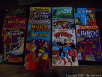 Photo showing the front cover of 11 comic books with characters such as Bugs Bunny, Spider-Man, Tom and Jerry, Superman, and others.