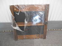 Front view of the rustic solid wood framed chalkboard wrapped in plastic, showing wood grain and metal hinge detail.
