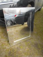 Front view of the stainless steel medicine cabinet with reflective glass door showing footprint and bezel.