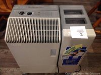 Front view of beige and gray Bionaire humidifier with vented front panel and top control panel, showing unit's size and condition.