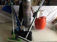Overall lot view showing vacuum, brooms, mop bucket, dustpans and mop handles