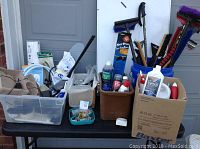 Overall view showing assorted fluids, cleaning tools, screws, and storage containers including totes and pails.