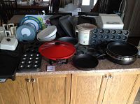 Overview of all kitchen items including bread maker, griddle, crock pot, various pans and muffin tins