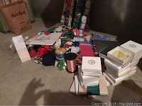 Photo showing piles of boxed Heritage Collection Ornaments stacked neatly alongside gift wrapping supplies like ribbons and bows.