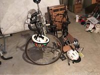 Overview of silver Bianchi road bicycle, two helmets, cardboard box of parts, and Rhode Gear bike rack