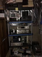 Three plastic shelving units assembled with vintage electronics (not included). Two units 72" tall, one 75" tall with black and gray plastic and blue trim on shelves.