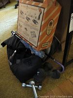 Lot showing vintage golf putting green box positioned on top of umbrellas and bowling bag with weights around.