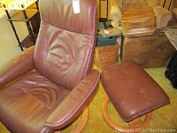 Swivel chair and ottoman showing overall condition and upholstery.