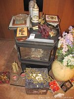 Wood carved dragon, German Shepherd figurine, German stein, glass bowl, wall art, miniature sword and sewing notions on and around stove area