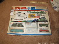 Full front view of the Lionel HO Gauge Electric Train Set original box showing the product name, train image, track layout illustration, and piece count.