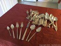 Assortment of forks, knives and spoons arranged on table