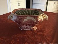 Photo of Mason's Ironstone flower vase showing scenic red transferware pattern, ornate handles, decorative base, and top flower divider grid.