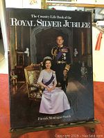 Front cover of a hardcover book titled 'The Country Life Book of the Royal Silver Jubilee' by Patrick Montague-Smith featuring Queen Elizabeth II and Prince Philip.