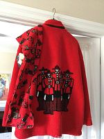 Back view of red fleece jacket showing stitched Mountie group design and hanging matching scarf with Mountie print.