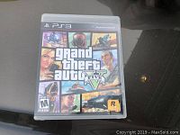 Front cover of the Grand Theft Auto V PlayStation 3 game case displaying title and artwork.