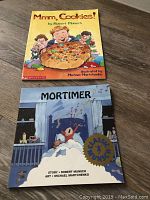Photo showing two children's soft cover books by Robert Munsch: 'Mmm, Cookies!' and 'Mortimer'.