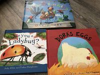 Photo of three hardcover children's books including Sunny Patch Kids, Are You a Ladybug?, and Dora's Eggs showing their colorful illustrated covers.