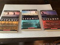 Photo showing three softcover young adult books by Gordon Korman titled Titanic Book One - Unsinkable, Book Two - Collision Course, and Book Three - S.O.S.