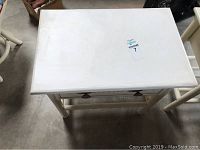 Top view of one white wooden nightstand showing surface and legs