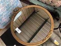 31 inch round gold framed mirror showing overall item and frame details.