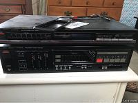 Front and side view of the Fisher AM/FM stereo synthesizer tuner and integrated stereo amplifier unit with labeling and controls visible.