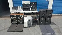 Overview of all components arranged outdoors showing speakers, subwoofers and electronics