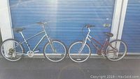 View of both mountain bikes side by side showing frame shapes, colors and overall condition