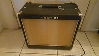 Front view of Tech 21 Power Engine 60 guitar amplifier showing black tolex and beige speaker grille with Tech 21 logo.