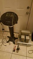 Singing Machine Classic karaoke system on black stand, three microphones on floor, Onkyo HT-R320 receiver and five speakers stacked on floor