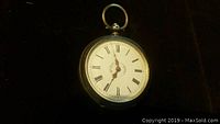 Front of pocket watch showing white dial with black Roman numerals and decorative gold hands.