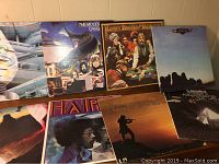 Photo showing 7 of the 11 LP record covers including The Moody Blues, Kenny Rogers & The First Edition, Eagles, Styx, and others with colorful album artwork.
