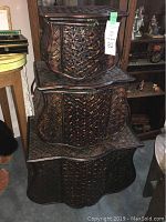 Set of three nesting wicker and wood storage basket chests stacked vertically