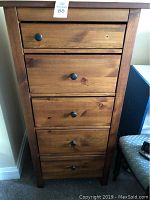 Front view of the tall chest showing five drawers with one knob missing on top drawer.