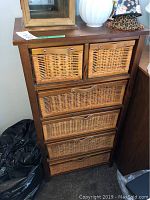 Front view of 6 drawer wicker chest showing wood frame and wicker drawers