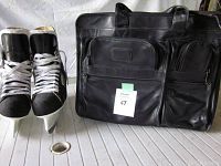 Photo shows black Bauer men's ice skates size 8 with white laces next to Tumi black leather computer shoulder bag with labels