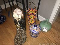 Lot including Indonesian puppet, ceramic jar with lid, green ceramic vase, and three-tier ceramic plate stand
