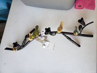 Top view showing the full length of the metal candle holder with seven bird figurines attached along the twisted metal branch and the bent section visible.