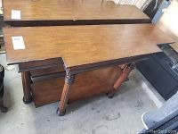 Photo showing side view of table legs and underside shelf area with visible scratches and wear.