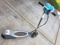 Angled top side view highlighting the Razor branding on the deck and overall scooter shape and tire condition.