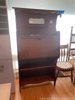 Front view showing closed drop-front and lower shelves