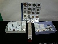 Overview of coin assortment in two plastic trays, a long red flip box, and binder page filled with individual flips