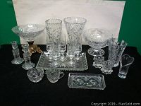 Complete assortment of crystal items on display including bowls, vases, tray, candlestick holders, and heart-shaped vase