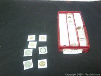Photo showing red storage box filled with rows of 2x2 cardboard coin holders containing various Hong Kong coins.