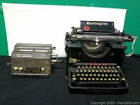 Front view of Remington typewriter and Facit calculator side by side showing keys and overall condition