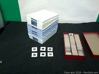 Four white plastic stackable trays, red flip organizer and six sample coin flips.
