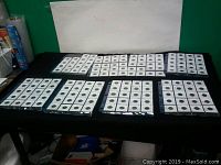 Overview of eight sheets of coin flips laid out on table