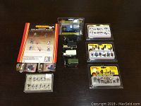 Overall assortment of small figures and model train accessories laid out on a table