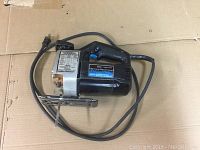 Photo of Sears Craftsman jigsaw power tool with cord wrapped around it on cardboard surface, showing full side profile.