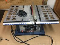Front view of Ryobi 10 inch table saw showing the work surface, fence and adjustment knob.